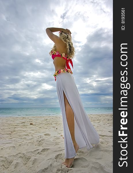 Girl stretching into the sky away from the beach