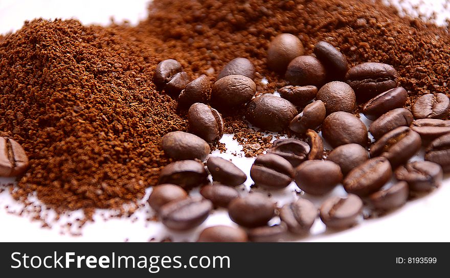 Coffee  is ground and in grains, macro, focus in a center