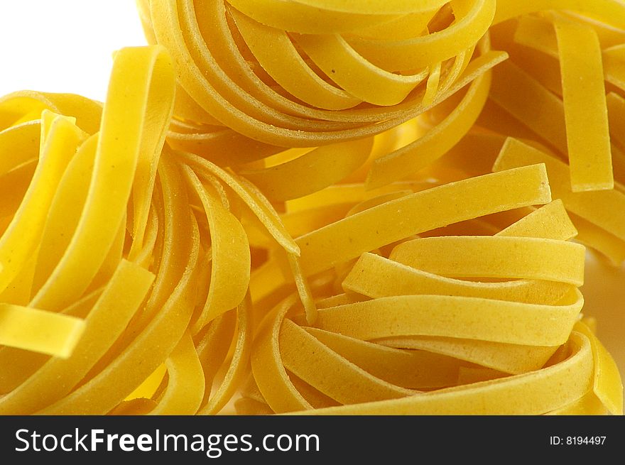 Tagliatelle pasta isolated on white background close up
