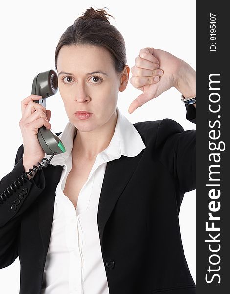 A woman in a business role indicating bad news with her thumb down. A woman in a business role indicating bad news with her thumb down.