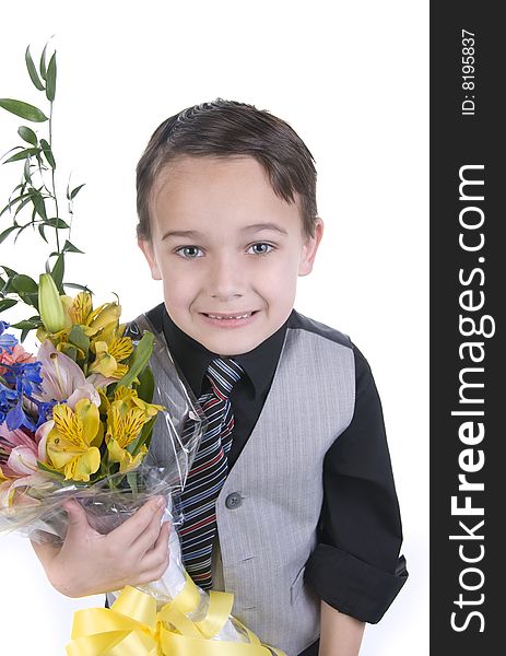 Image of small boy in suit presenting flowers as a gift. Image of small boy in suit presenting flowers as a gift