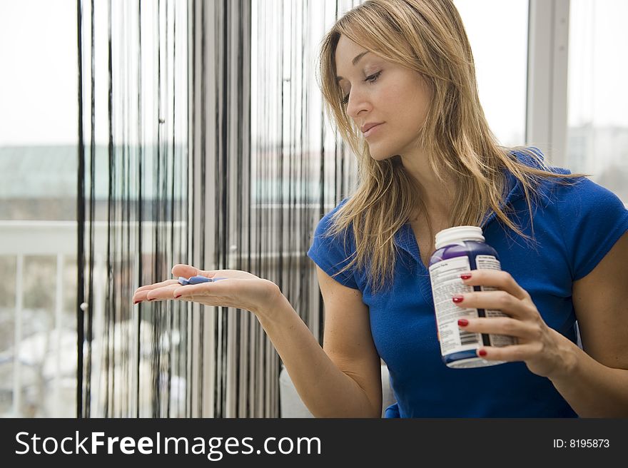 Woman taking a pill for her headache