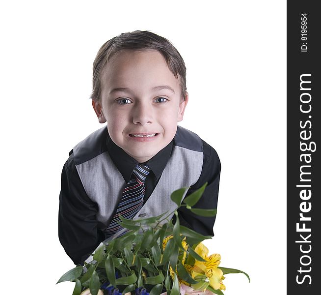 Image of small boy dressed in suit presenting flowers as a gift. Image of small boy dressed in suit presenting flowers as a gift