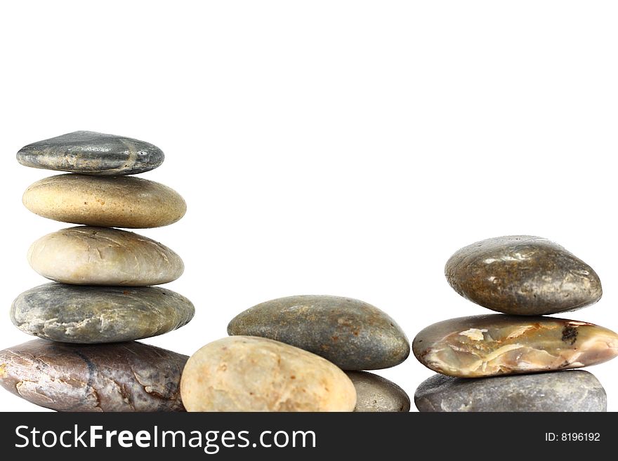 A selection of rocks balancing on a white background. A selection of rocks balancing on a white background