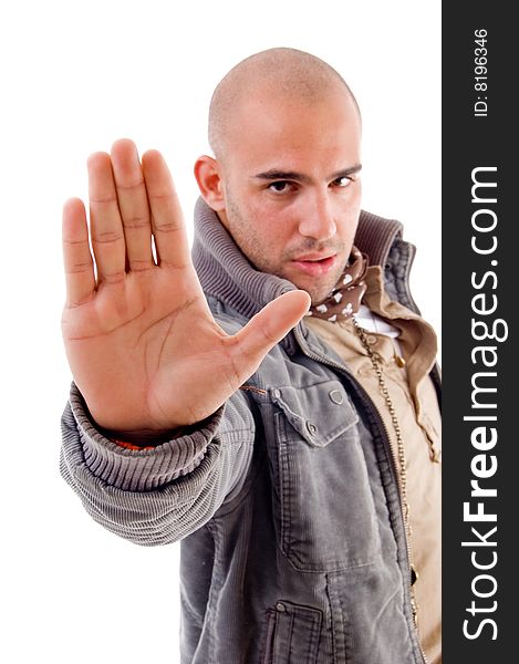 Young male with stopping hand gesture on an isolated background