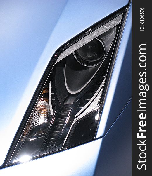 The headlight of a blue Lamborgini automobile, symbol of all that is class and sophistication. The headlight of a blue Lamborgini automobile, symbol of all that is class and sophistication.