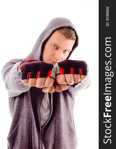 Young male showing fists against white background