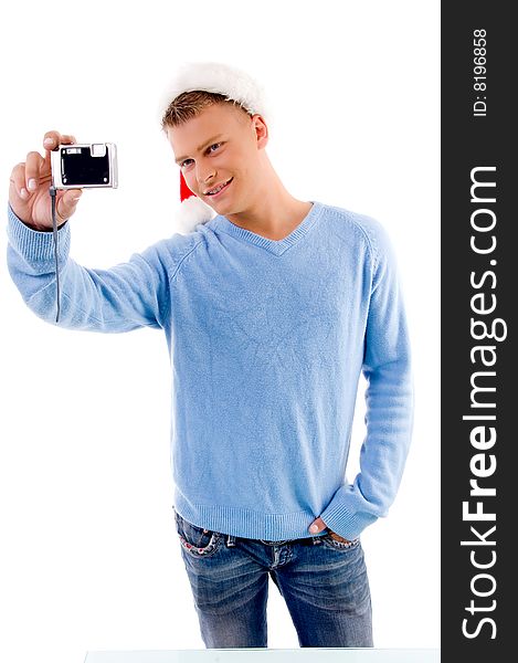 Adult guy posing with christmas hat and camera on an isolated background. Adult guy posing with christmas hat and camera on an isolated background