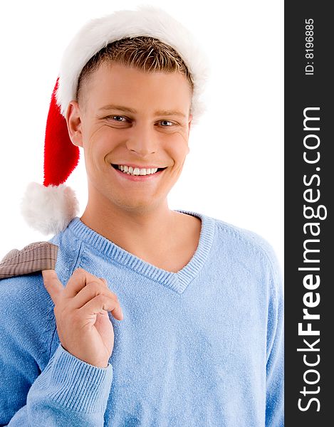Smiling young man with christmas hat looking at camera against white background. Smiling young man with christmas hat looking at camera against white background