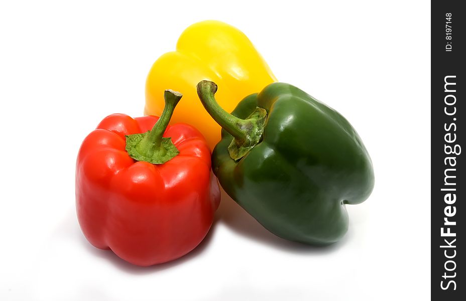 Three different color peppers on white background