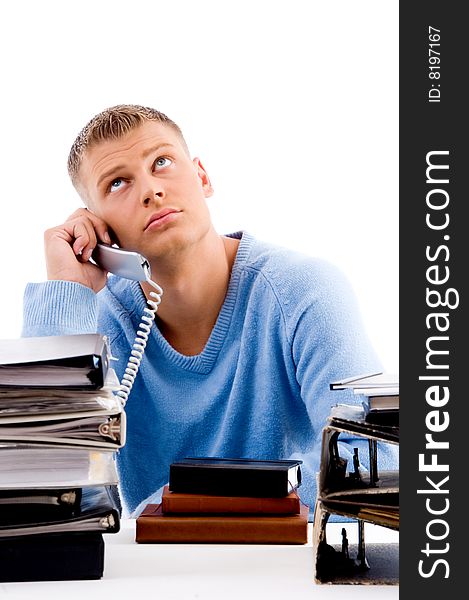 Young professional with phone looking upward in an office. Young professional with phone looking upward in an office