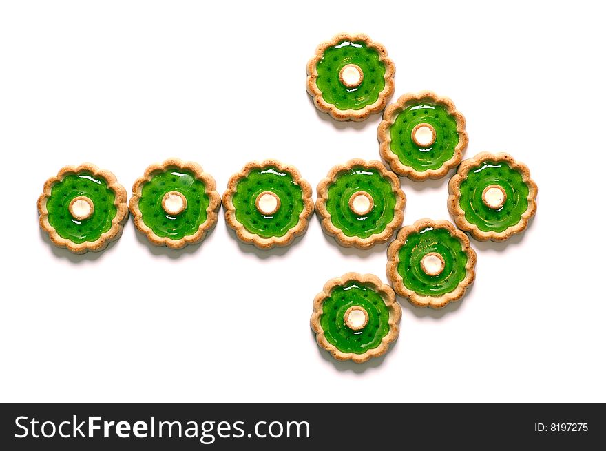 Cakes with green jelly in the form of arrow isolated on white