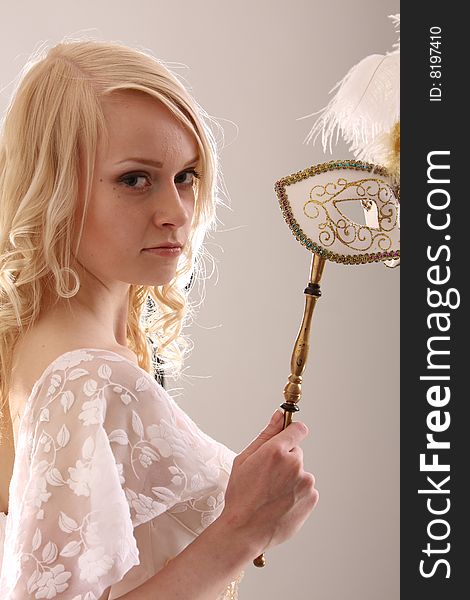 Beautiful young woman with Venetian mask, studio photo. Beautiful young woman with Venetian mask, studio photo