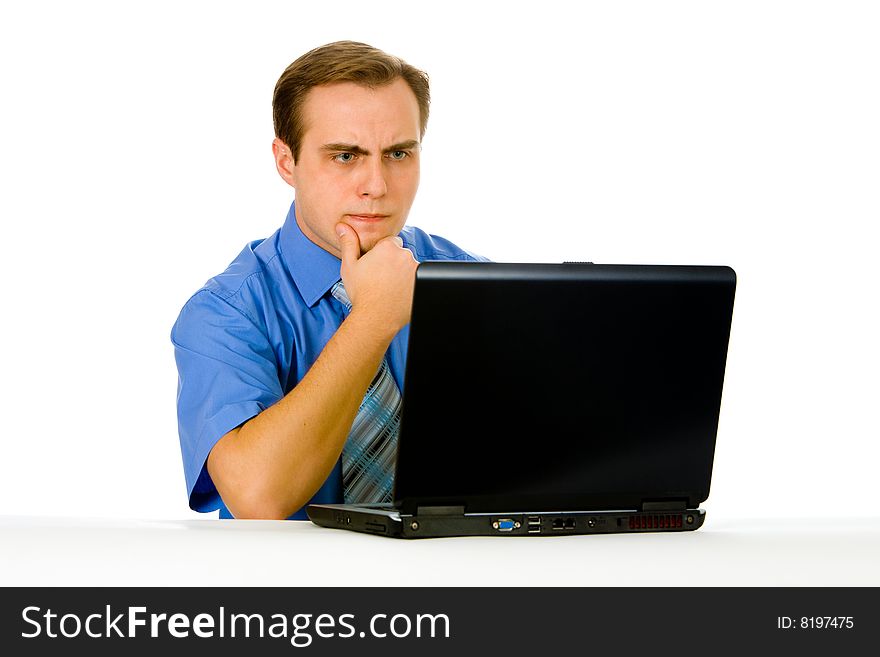 Young businessman working on a laptop. Isolated on white.