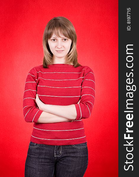 Studio shot of a pretty young woman on a red background. Studio shot of a pretty young woman on a red background