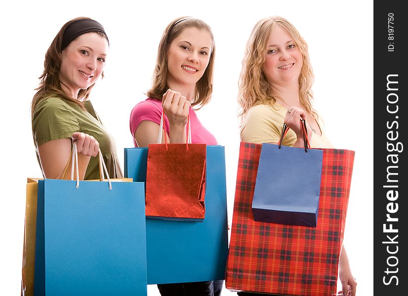 Three girls with shopping bags. Isolated on white