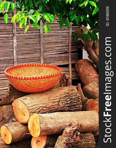 Reed basket on wooden logs shot in vietnam