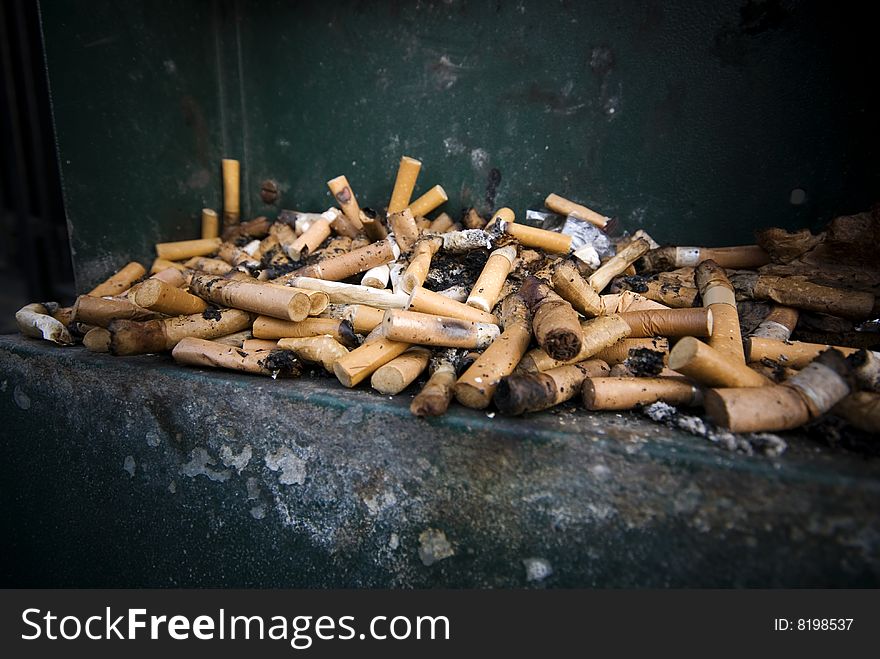 Selective focus of Large number of cigarette butts, close-up. Selective focus of Large number of cigarette butts, close-up.