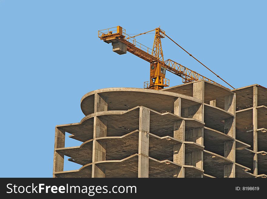 View of monolithic housebuilding with crane. View of monolithic housebuilding with crane
