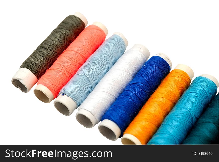 Colored sewing threads on white