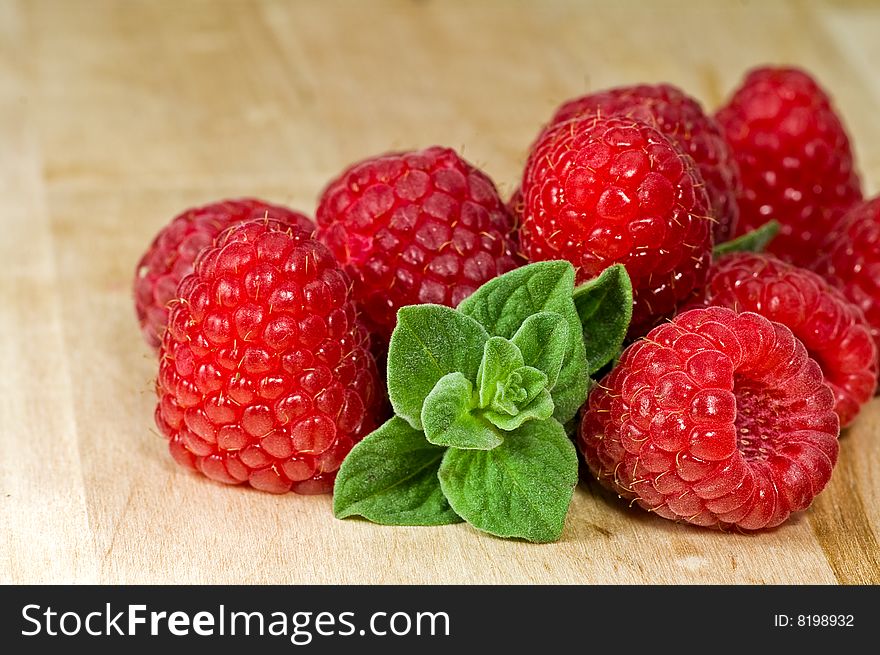 Fresh ripe raspberry and mint leaves