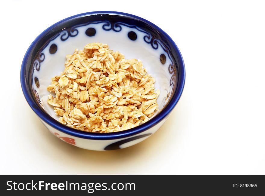 Bowl of granola on white background