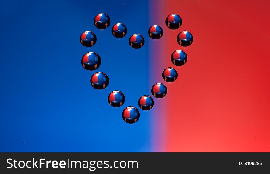 Water drops in the form of heart on a celebratory background