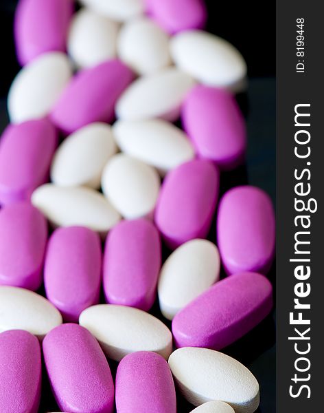 Colored oblong pills on the isolated background