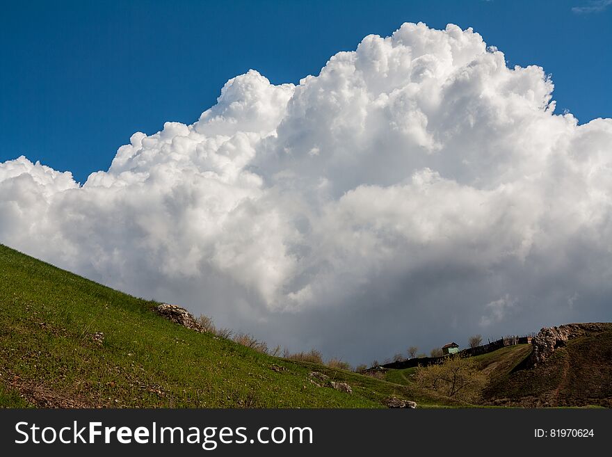 Big cloud over a small house. Big cloud over a small house