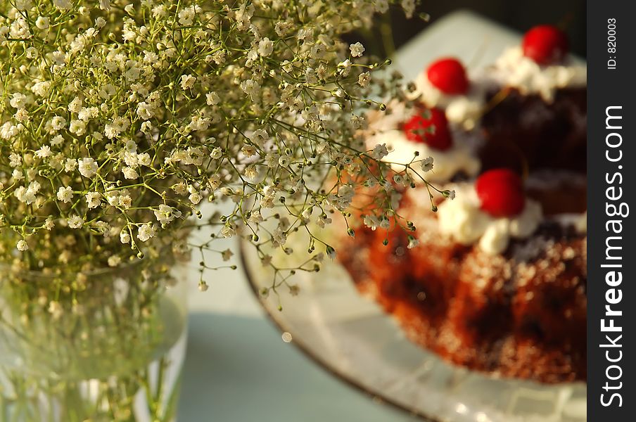 Cherry cake with flowers at a sunset light