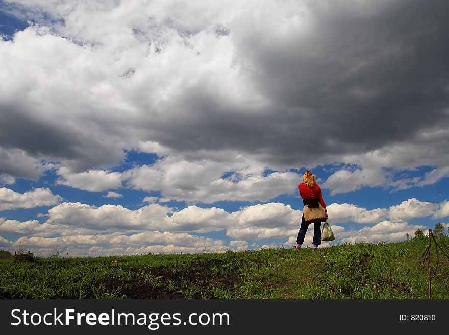 Woman, road and clouds. Sibir. Russia.