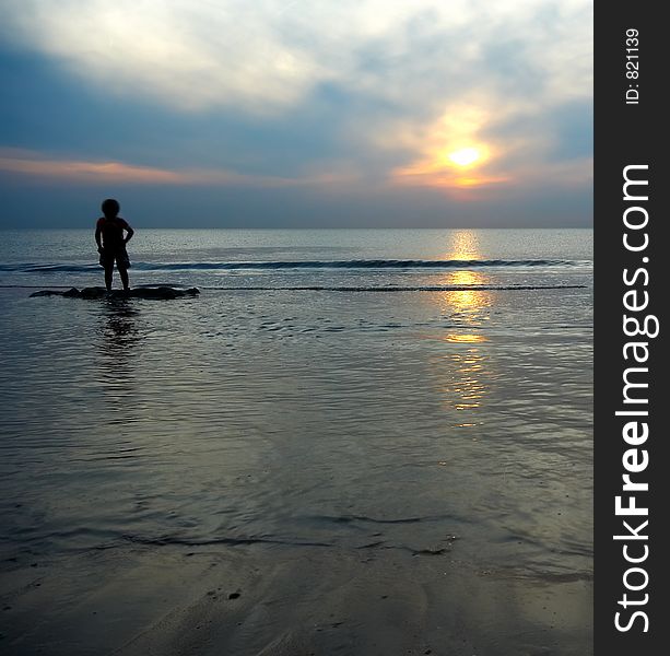 Boy Playing At The Beach