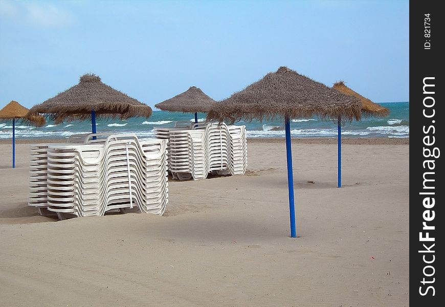 Umbrellas And Chairs In The Beach