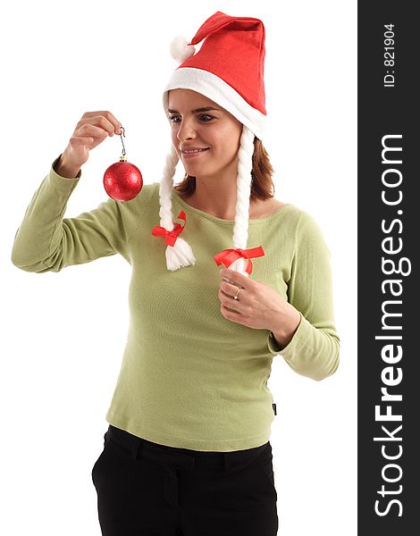 Portrait of a young woman wearing Santa hat holding red Christmas tree ornament. Portrait of a young woman wearing Santa hat holding red Christmas tree ornament
