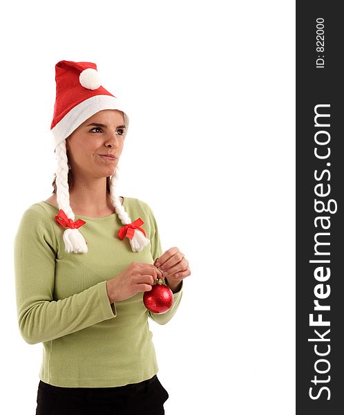 Portrait of a young pretty woman wearing Santa hat, holding red Christmas tree ornament. Portrait of a young pretty woman wearing Santa hat, holding red Christmas tree ornament