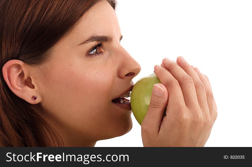 Young woman eating green apple