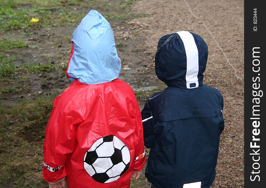 Young football fans in rainy day