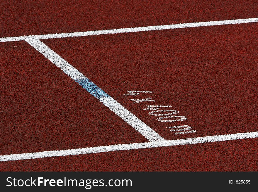 Closeup of a single red track lane, with 4x400m mark on the tarmack. Closeup of a single red track lane, with 4x400m mark on the tarmack