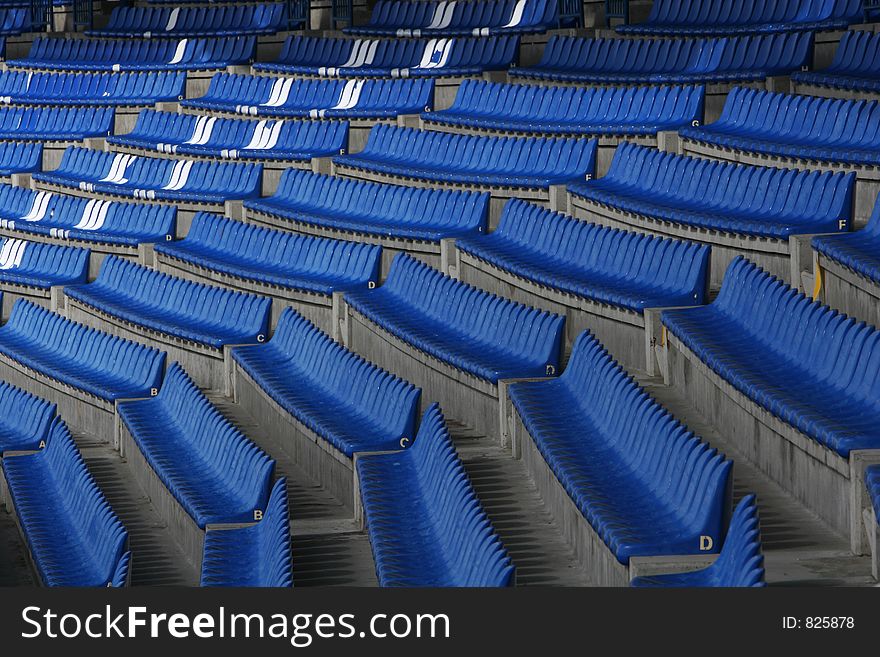 Blue audience seats at a football stadium