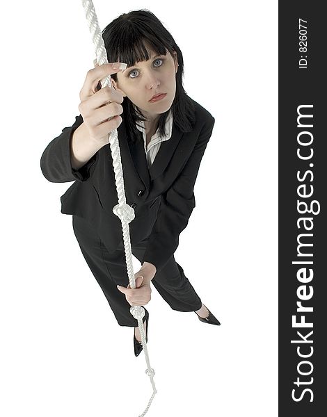 Young woman in business suit grasping a rope. Hopless expression. Full body. Young woman in business suit grasping a rope. Hopless expression. Full body.