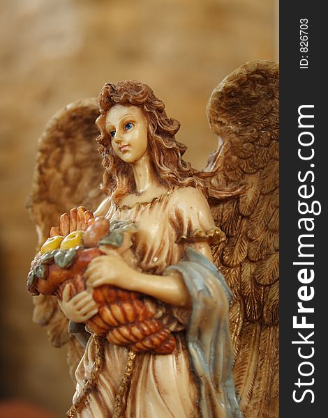 Angel carrying a basket of fruits. Angel carrying a basket of fruits