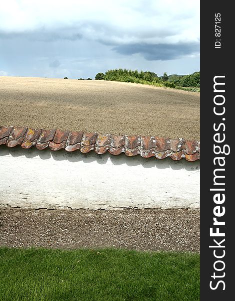 In the country nearby a danish village in the summer a wall in the sun. In the country nearby a danish village in the summer a wall in the sun