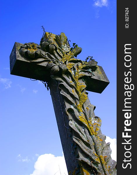 Shot looking up at a stone crucifix against a blue sky for use as a Christian symbol especially at Easter time. Shot looking up at a stone crucifix against a blue sky for use as a Christian symbol especially at Easter time.