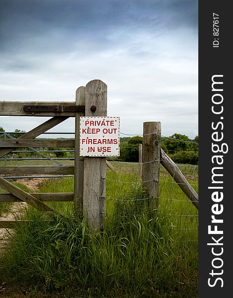 Private keep out, firearms in use warning sign