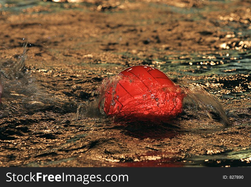 The image of a red ball on water. The image of a red ball on water