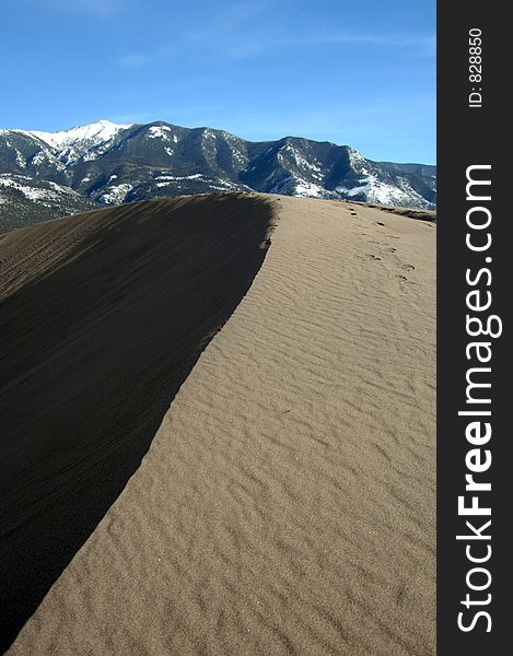 Great Sand Dunes during afternoon sun, casting a shadow. Great Sand Dunes during afternoon sun, casting a shadow