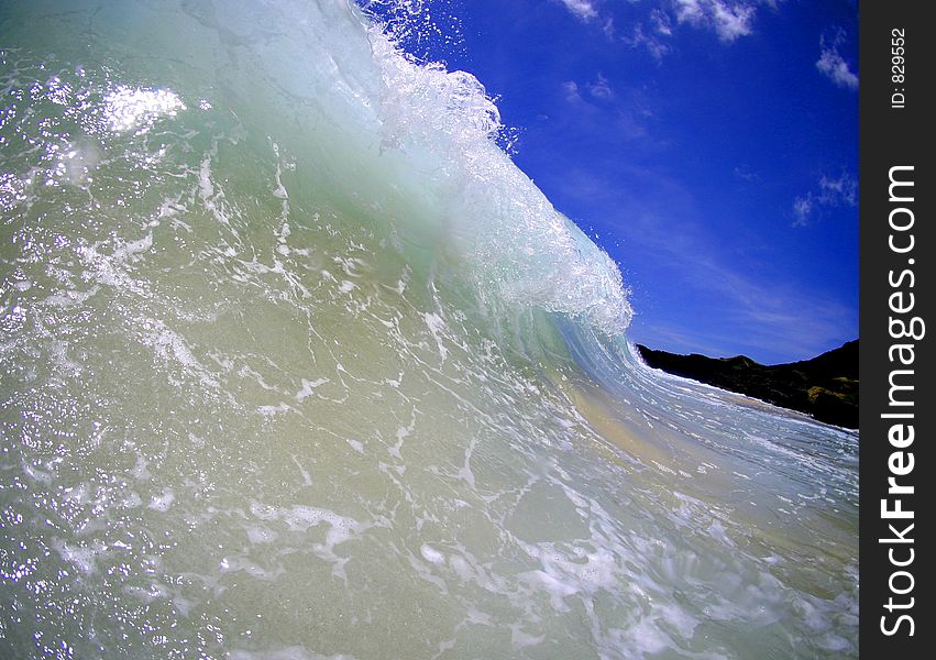 A wave curling towards the shore in Hawaii. A wave curling towards the shore in Hawaii.