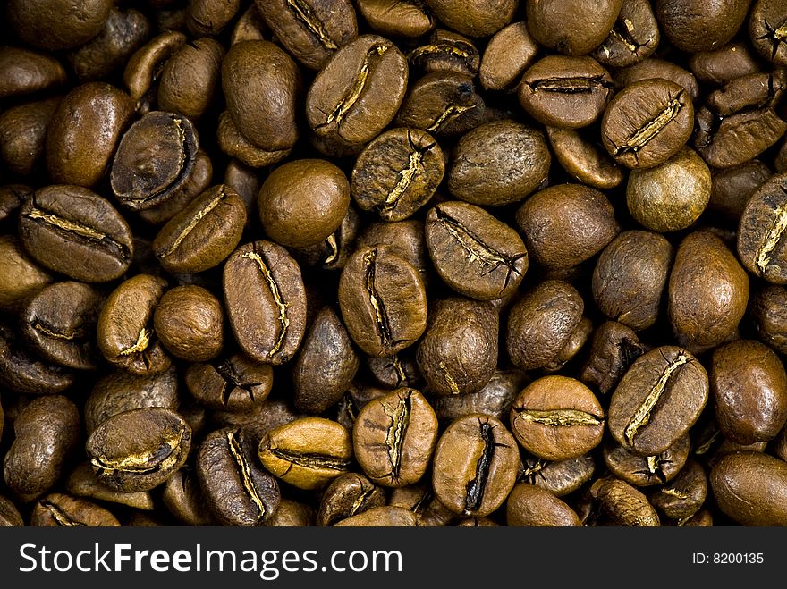 Background from the spilled grains of Brazilian coffee