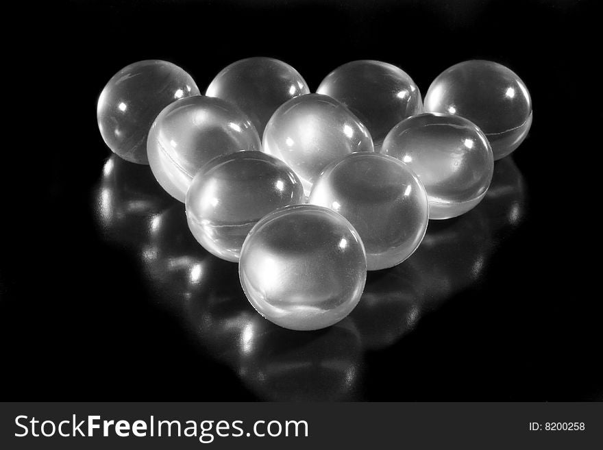 Rows of aromatic bath balls (on a black background, with beautiful reflections)