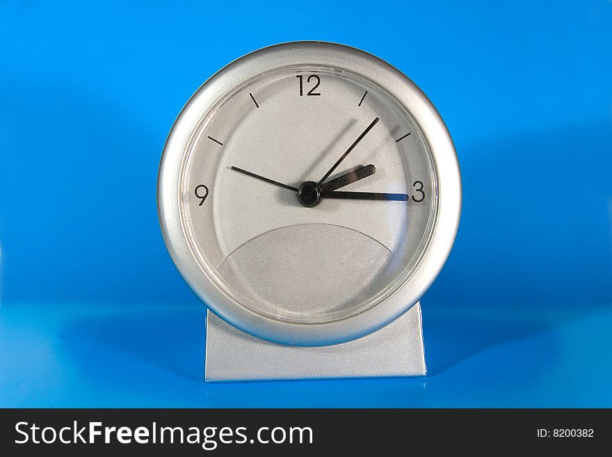 Simple gray desk clock (on a bright blue background)